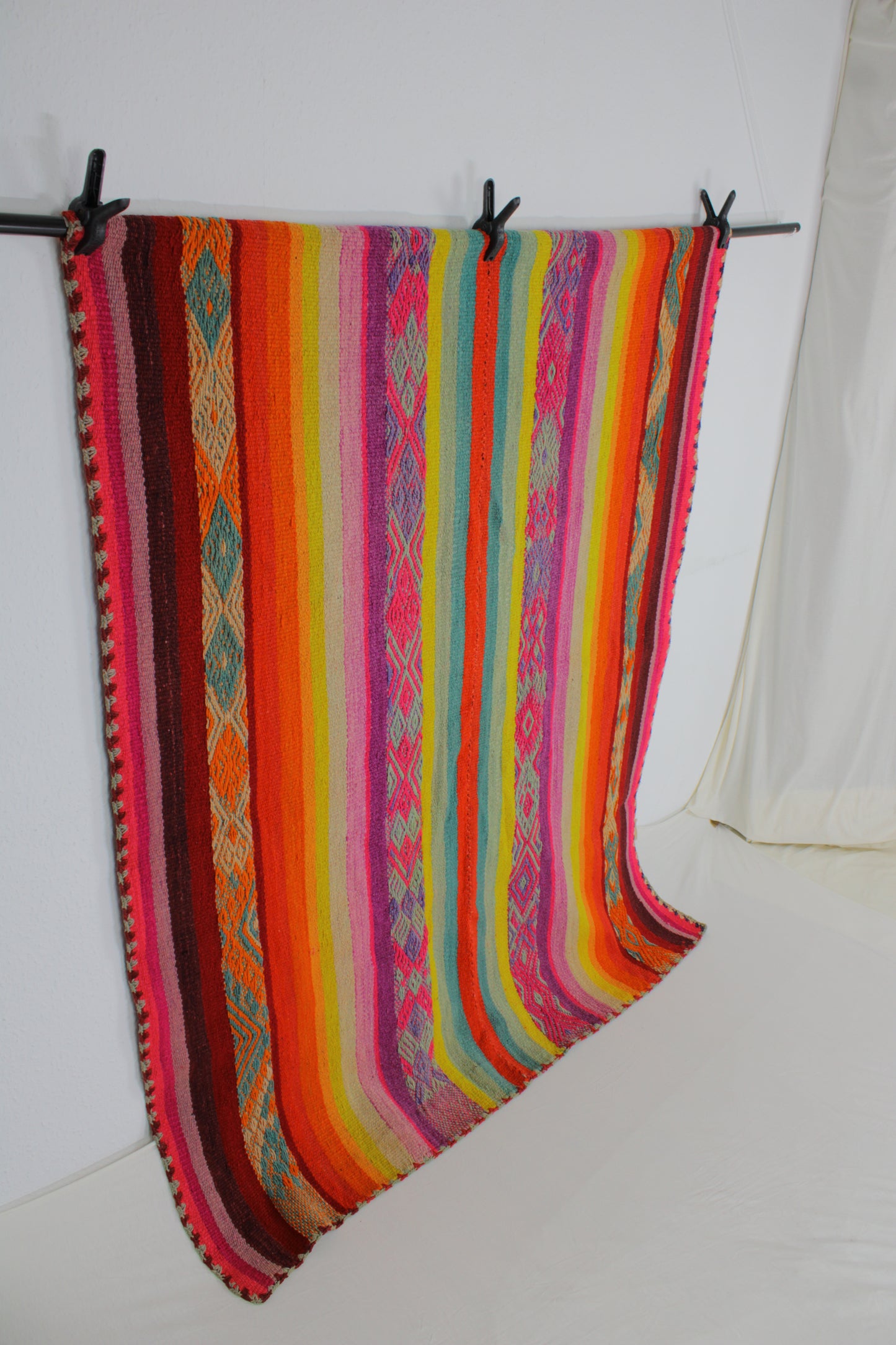 Handgefertigter Frazada-Teppich aus Peru – farbenfroh, traditionell und ideal für Balkon, Terrasse oder gemütliche Wohnräume. Dieser bunte Teppich bringt peruanisches Kunsthandwerk und Wärme in dein Zuhause und setzt lebendige Akzente im Boho- oder Ethno-Stil für drinnen und draußen.