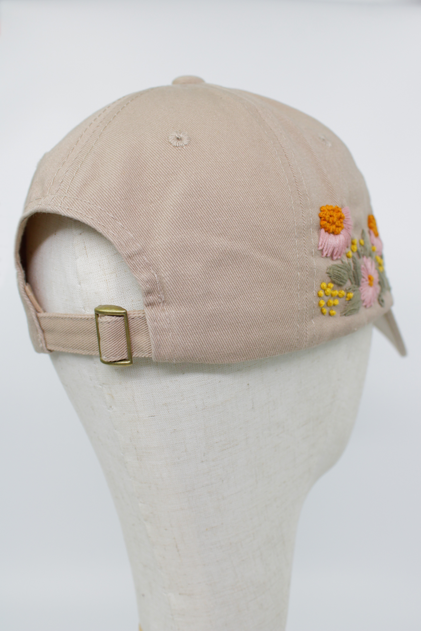 Handbestickte beige Cap von Glueck & Fund, modisches Accessoire mit kunstvollen Stickereien, bequem und stilvoll.