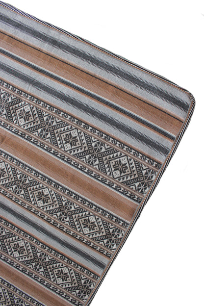 Peruanische Baumwoll-Tagesdecke mit traditionellem Andenmuster in einem modernen, minimalistischen Schlafzimmer. Handgewebtes Kunsthandwerk aus Peru als stilvoller Boho-Wohnakzent.