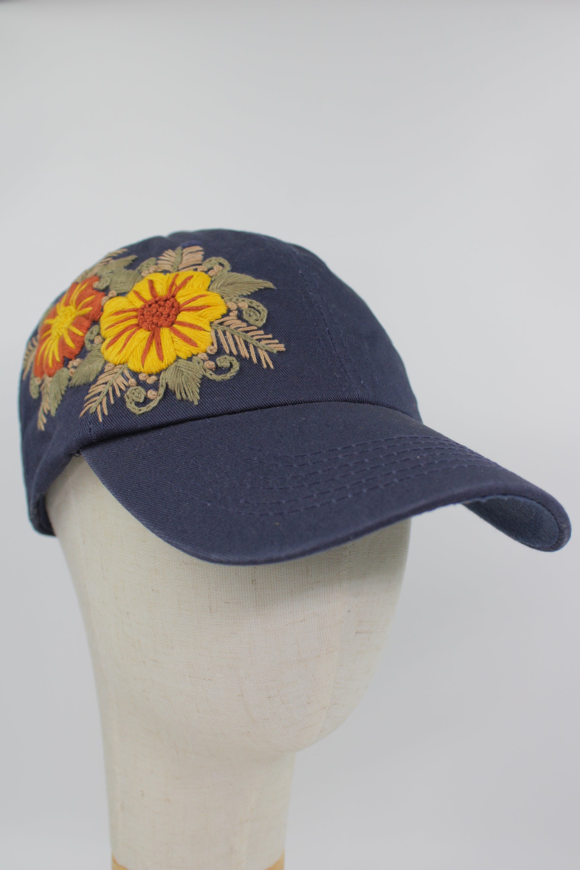 Handbestickte dunkelblaue Cap von Glueck & Fund, modisches Accessoire mit detailreicher Stickerei, bequem und stilvoll.