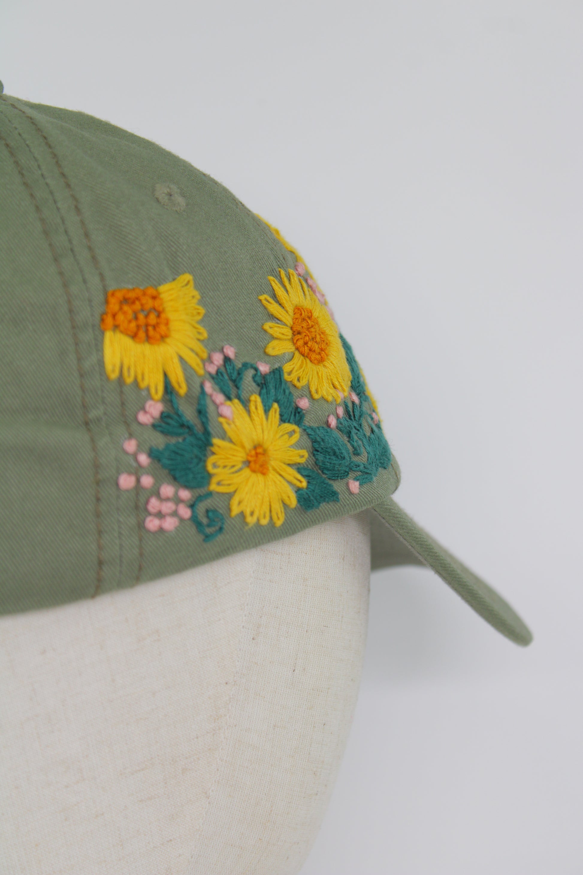 Handbestickte Khaki Cap von Glueck & Fund, stylisches Accessoire mit filigranen Stickmustern, weicher Stoff und bequemer Sitz.